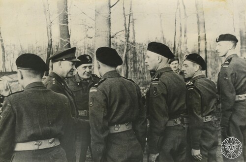 Naczelny dowódca sił alianckich generał Dwight Eisenhower (2L) i dowódca polskiej 1. Dywizji Pancernej generał brygady Stanisław Maczek (3L) rozmawiają z polskimi żołnierzami podczas inspekcji na froncie zachodnim w Holandii. Listopad 1944 r. Fot. z zasobu IPN