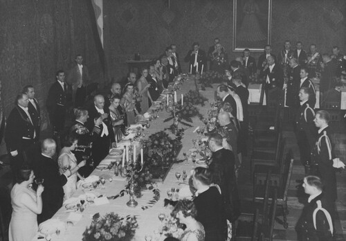 Visit of the Hungarian regent Miklos Horthy in Poland, February 1938. A solemn dinner at the Senator Hall at the Wawel castle. President of the Republic of Poland Ignacy Mościcki (fifth from the left behind the table) raises a toast for Miklos Horthy (fourth from the left). Also visible are: the minister of military affairs, division general Tadeusz Kasprzycki (seventh from the right behind the table), minister of foreign affairs Józef Beck (seventh from the left on the right side of the table),