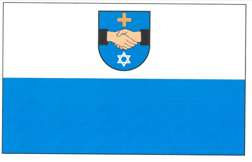 Flaga przedstawia prostokątny płat składający się z dwóch równych poziomych pasów. W górnej części herb, który przedstawia dwie uściśnięte dłonie. Nad dłońmi umieszczony jest krzyż równoramienny, pod dłońmi umieszczona jest gwiazda Dawida.