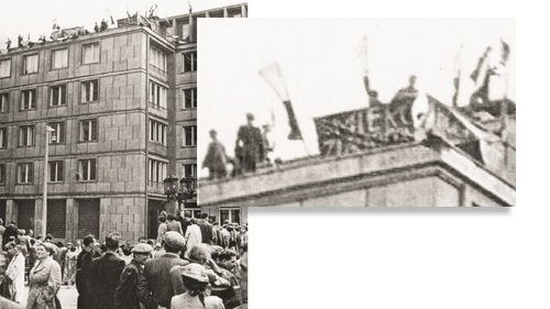 Widok piętrowego budynku miejskiego wraz z przybliżeniem na grupę osób znajdująca się na dachu budynku.