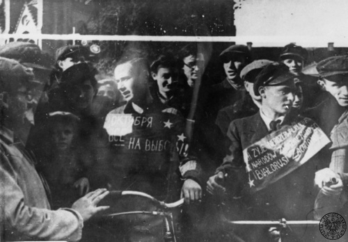 Agitacja za przyłączeniem Białostoczczyzny do ZSRS, 1939 r. W otoczeniu grupujacych się ludzi dwaj mężczyźni z rowerami; jeden z szarfą w języku rosyjskim, drugi z napisem po polsku: "NIECH ŻYJE NIEROZERWALNY BRATERSKI [ZWIĄZEK] NARODÓW ZWIĄZKU SOWIECKIEGO I BIAŁORUSI ZACHODNIEJ". Fot. AIPN