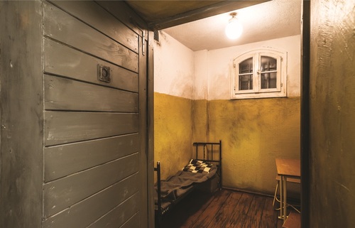 Zrekonstruowana cela więzienna, w której przetrzymywano uczestników Poznańskiego Czerwca. W pomieszczeniu piwnicznym z zaślepionym oknem, ściany pomalowane farbą. Pod ścianą metalowe łóżko, obok stolik.