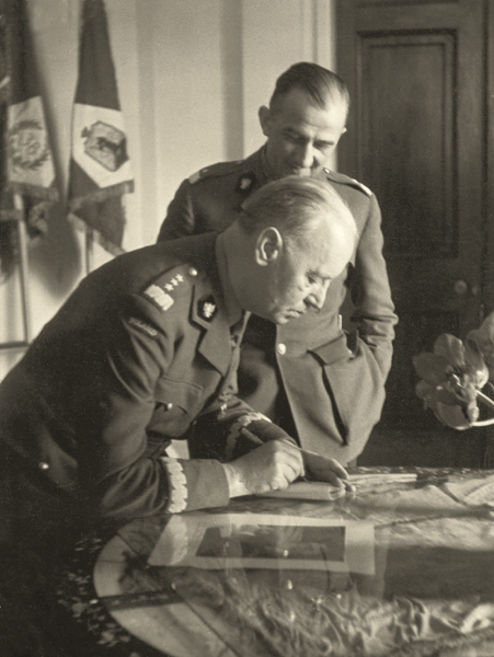 General Władysław Sikorski signing documents in his office of the Prime Minister of the government-in-exile, next to him General Tadeusz Klimecki, Chief of Staff of the Commander-in-Chief