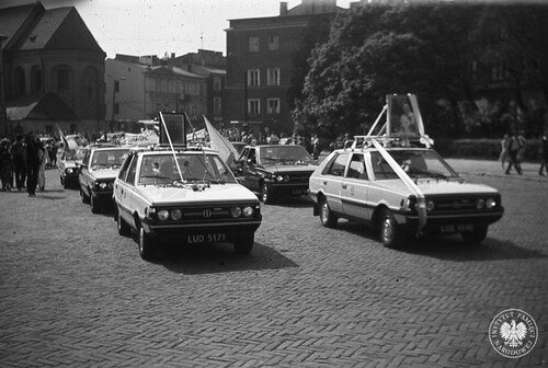 A ceremonial ride of Lublin taxi drivers through the streets of the city for the health and recovery of John Paul II after the assassination attempt on his life. The photo shows a dozen or so taxis in front of the Lublin Archcathedral of St. John the Baptist and St. John the Evangelist, on the right one of the tenement houses on Królewska Street. Lublin, Cathedral Square, May 1981 (photo from the Institute of National Remebrance Archives)