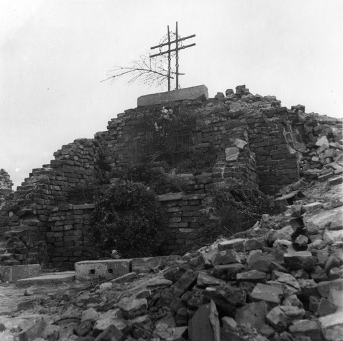 Prowizoryczny ołtarz wśród ruin Pawiaka, zburzonego podczas Powstania Warszawskiego. W pozostałości muru widoczna krata więzienna. Warszawa, 17 stycznia 1945 – 31 grudnia 1948 r. (fot. z zasobu AIPN)